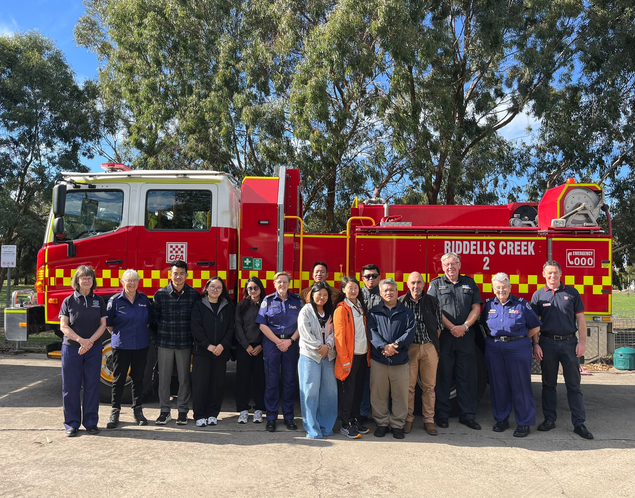 Yang (Front row, right, in dark blue jacket) during a visit to Riddells Creek Fire Brigade in Australia.