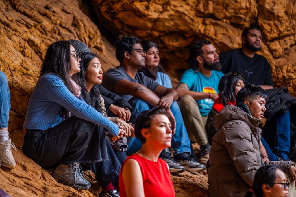 Guide John (in light blue t-shirt) leads a mindfulness exercise with Wangdi (right, middle) and Alice Tamang (in red dress), Indigenous Engagement Adviser at Australia Awards – South Asia & Mongolia during their visit to the Ikara-Flinders Ranges National Park.